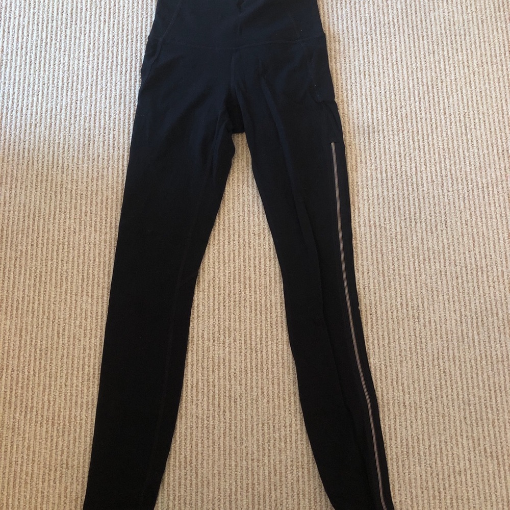 Athleta black leggings with gold zipper